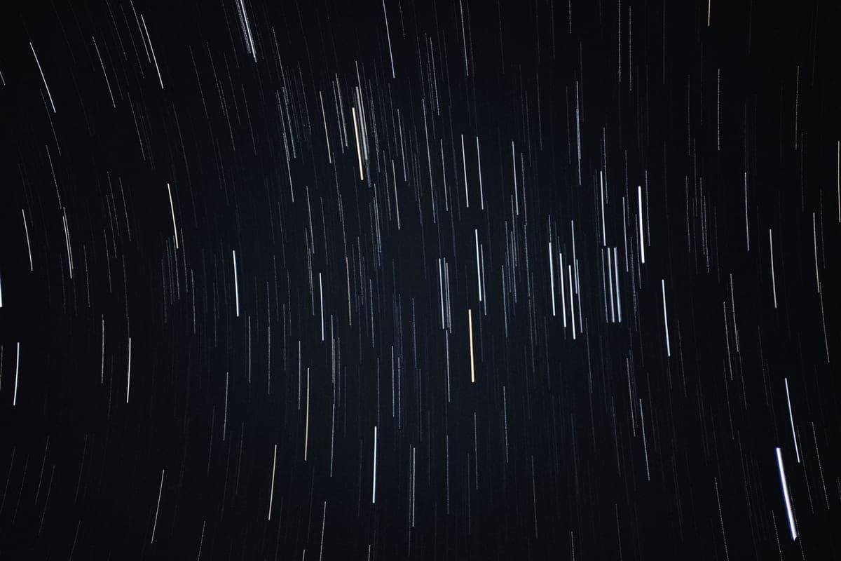 A long-exposure photograph of star trails circling the night sky