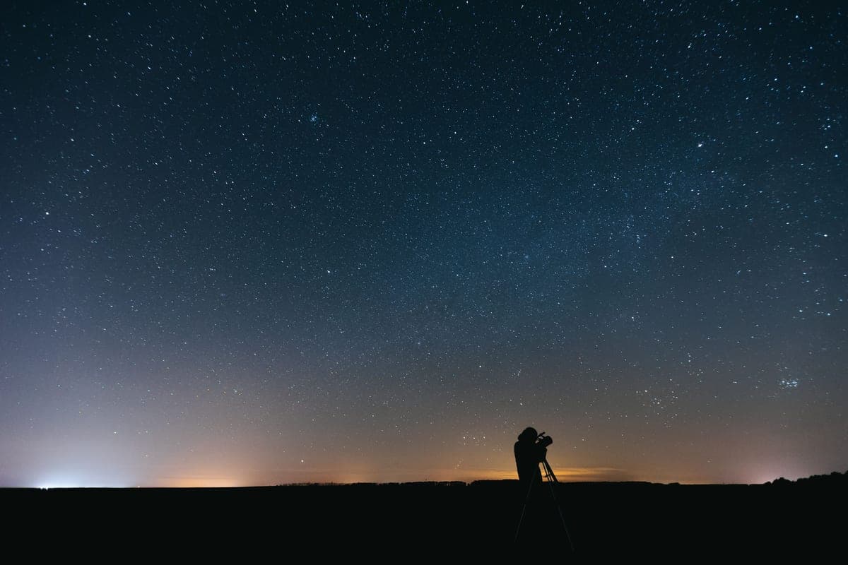 A person observing under a vast star-filled sky