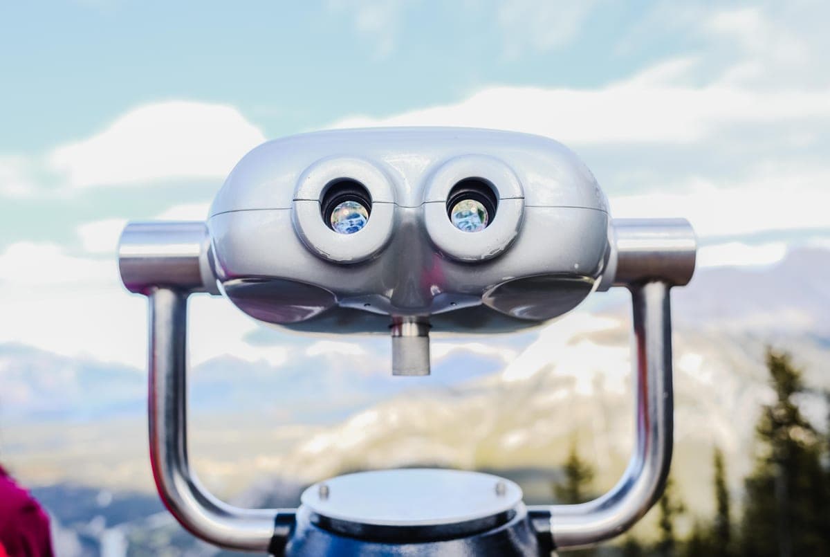 Coin-operated binoculars looking out over a mountain landscape