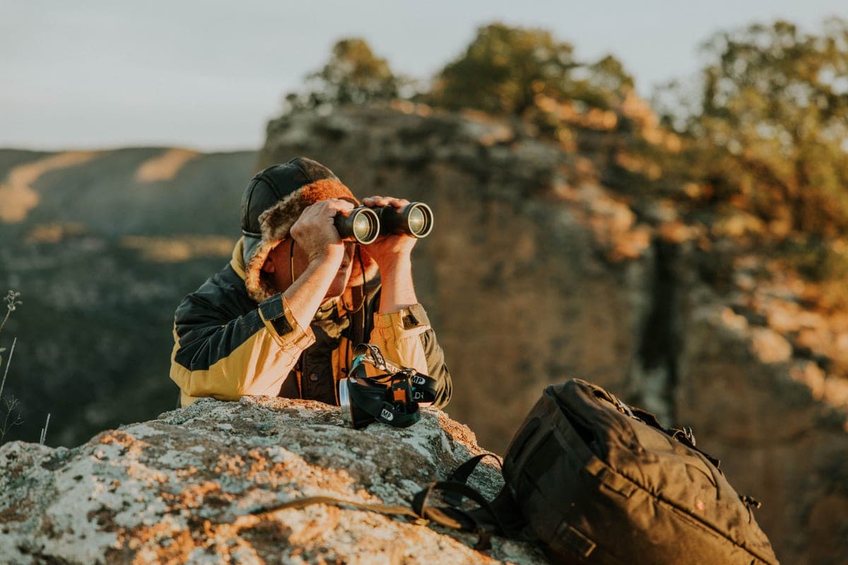 A pair of binoculars resting outdoors in daylight
