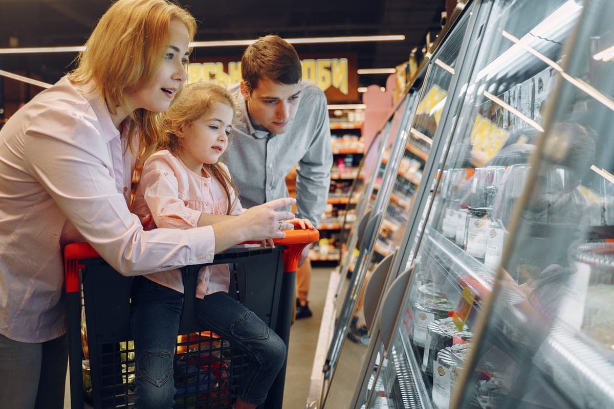 A family shopping together, considering what to buy
