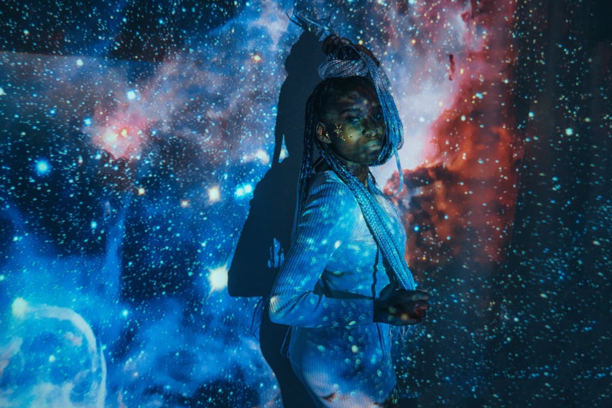 Colored nebula light projected across a dark ceiling