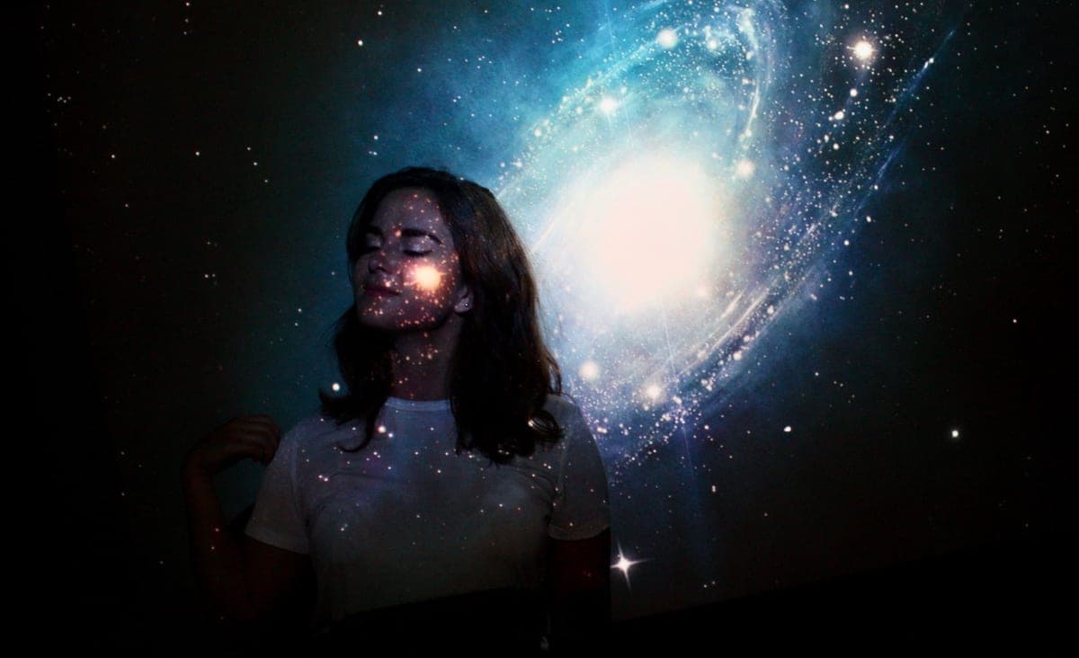 Projected white stars covering a dark bedroom wall and ceiling