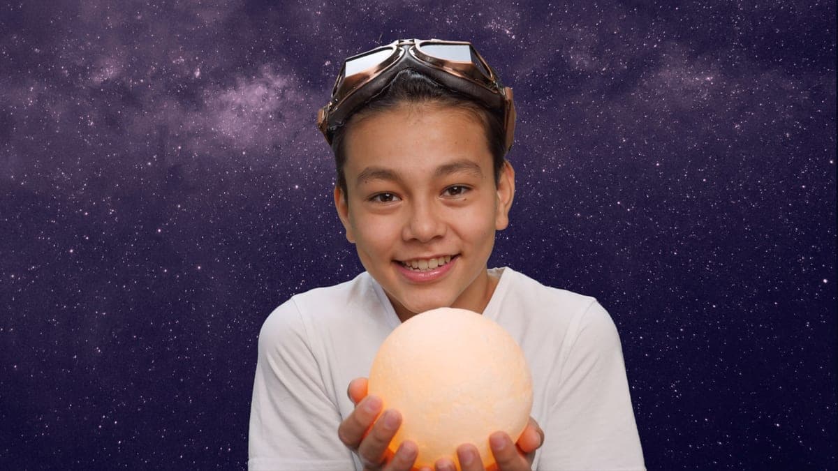 A teenager looking up at a star-filled night sky