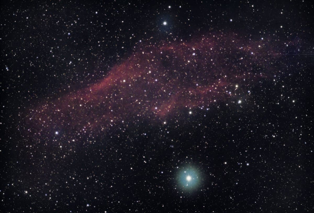A bright nebula and dense star field in deep space