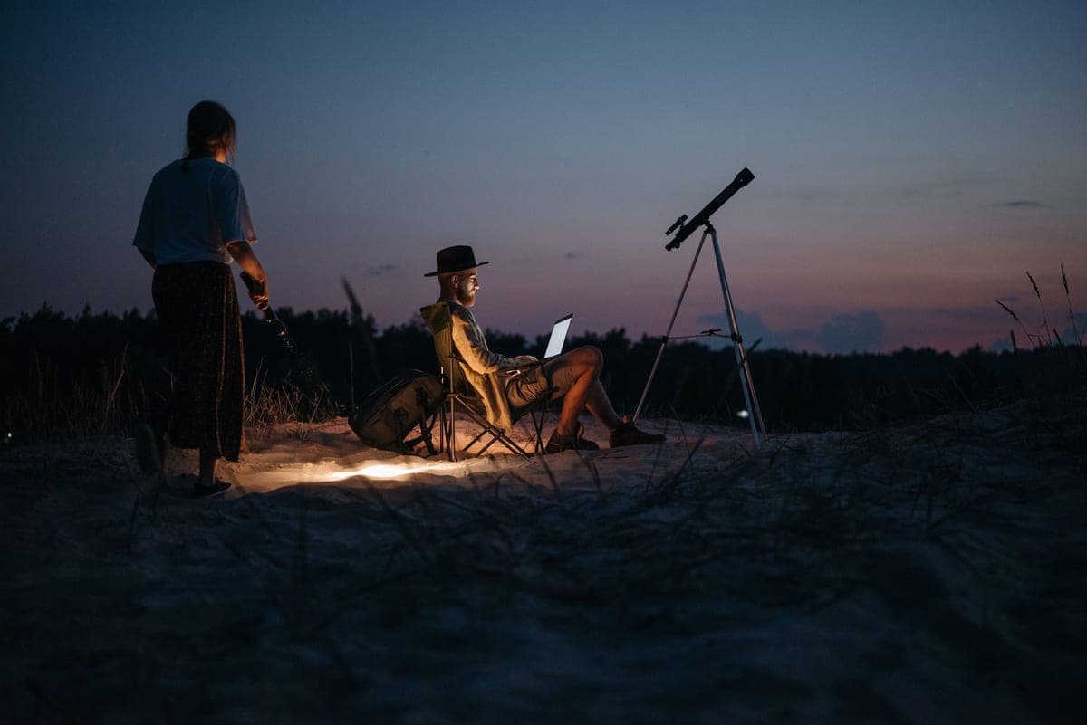 A telescope and backpack ready to be carried outdoors